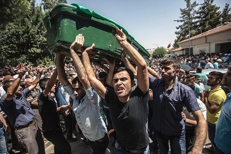 A funeral for victims of Saturday's attack on a wedding party in Gaziantep, Turkey, which left at least 54 dead. Mr Erdogan said ISIS had been trying to establish itself in the area, which is just 60km north of Syria and a major hub for refugees.
