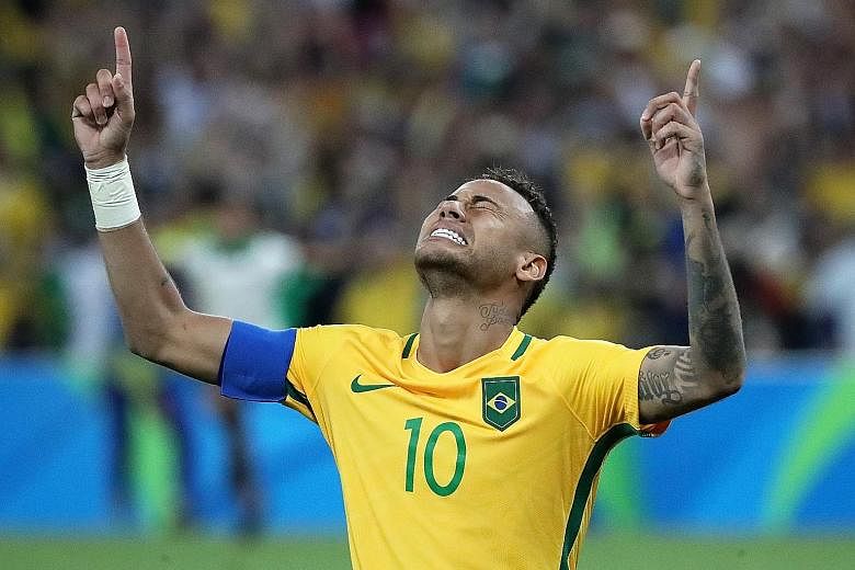 Neymar celebrates scoring the winning penalty that gave Brazil their first gold medal in Olympic men's football.