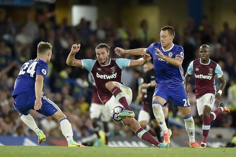 Chelsea skipper John Terry (right) vies for the ball with West Ham striker Andy Carroll in the Blues' 2-1 win at Stamford Bridge this month.