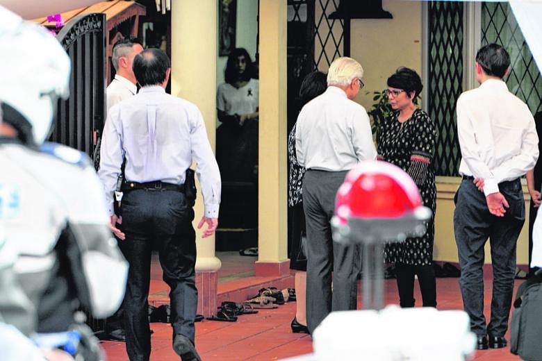 President Tan and his wife speaking to Mr Nathan's daughter Juthika Ramanathan at the family's Ceylon Road home, where they paid their respects. Visitors writing tributes to Mr Nathan on condolence boards at the Istana. People from all walks of life 
