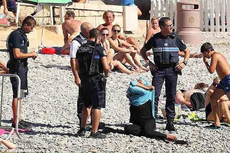 A photo showing a woman undressing in front of four police officers on the beach at the Promenade des Anglais in Nice, near the site where a truck attack took place last month. The photo went viral and sparked a furore on Twitter, with many criticisi