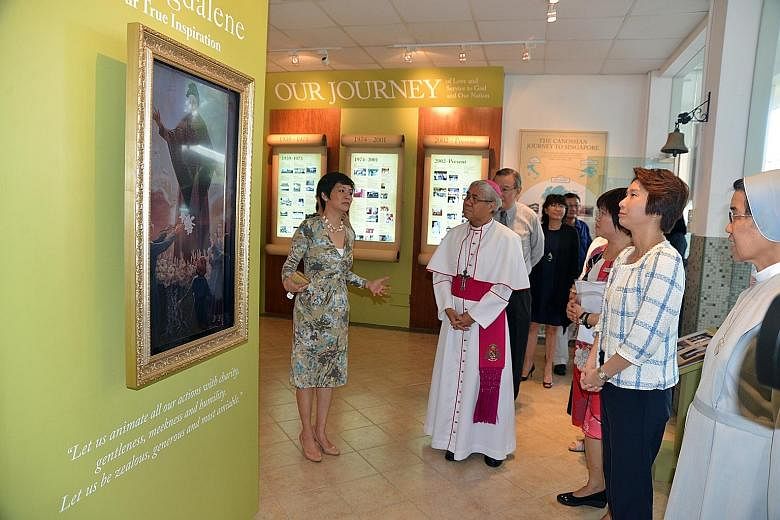 Front row, from left: Canossian alumni president Ms Veronica Tan, Archbishop William Goh, CCPS principal Ms Grace Tan, Ms Low Yen Ling and Sister Theresa Seow touring the Canossa Heritage Gallery. CCPS celebrated its 75th anniversary and its official