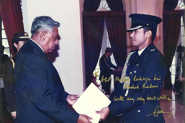 Mr Nathan giving Mr Redhza his appointment certificate when the latter was made an honorary aide-de-camp in 2001 after his stint as full-time ADC. The President later wrote a message on the photo as a keepsake for Mr Redhza.