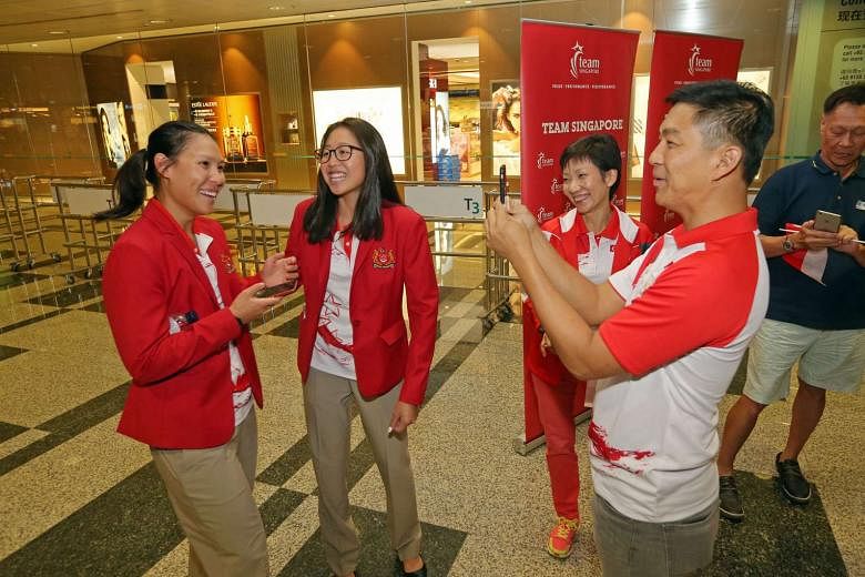 Minister for Social and Family Development Tan Chuan-Jin (right) interviews sailor Sara Tan (left) at Changi Airport. Sailor Amanda Ng and Minister for Culture, Community and Youth Grace Fu look on. 