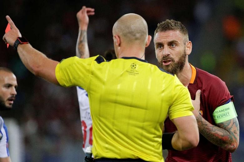 Midfielder Daniele de Rossi (right) pleading his case in vain after receiving the first of Roma's two red cards during the 3-0 defeat by Porto on Tuesday. The Serie A team, favoured to win despite drawing the first leg 1-1, never recovered after the visit