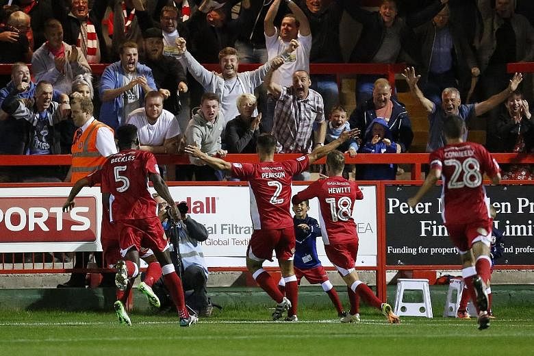 Accrington players celebrating their giant-killing feat after Matty Pearson's (No. 2) winner late in extra time gave the League Two side a 1-0 win over their Premier League opponents Burnley.