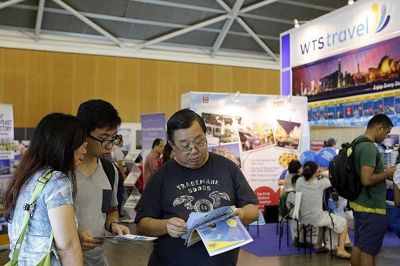 More travellers, including visitors at the Natas travel fair (left) earlier this month, are buying travel insurance or as part of their travel packages.
