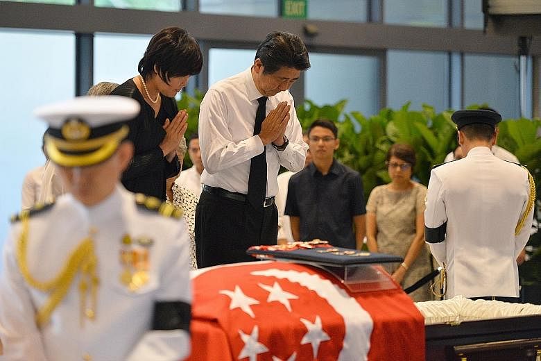 Mr Abe and his wife Akie paying their last respects to Mr Nathan at Parliament House yesterday. In a condolence message, the Japanese Prime Minister described him as a "cornerstone of unity" for Singaporeans.