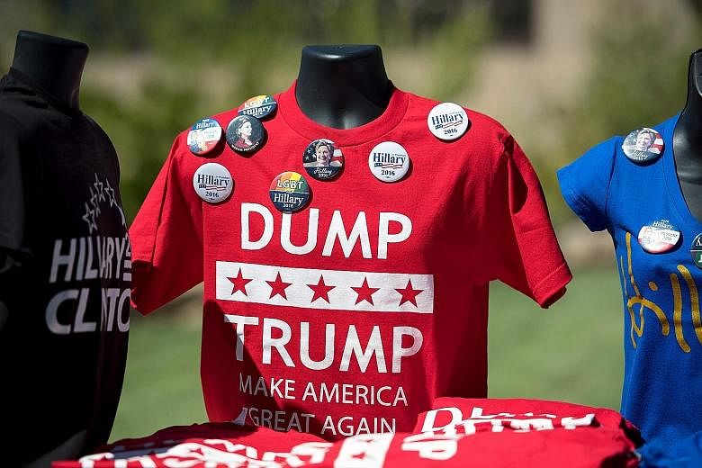 Shirts and pins on sale outside a campaign event where Mrs Clinton was due to speak in Reno, Nevada, on Thursday. Mrs Clinton listed nearly every racially insensitive comment Mr Trump has made.