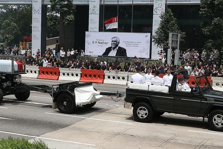 Above: Staff lining the street in Collyer Quay in front of NTUC Centre as Mr Nathan's funeral procession passed. From far left: Visitors watching the state funeral service live on TV at the National Library building in Victoria Street; and people fro