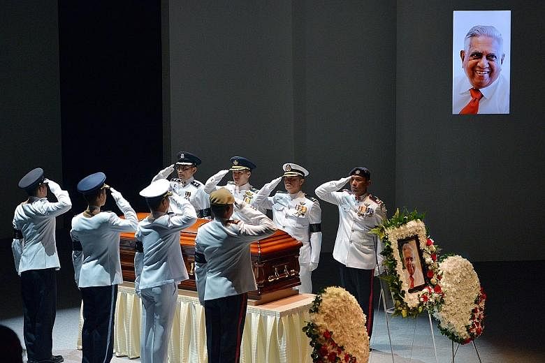 Final salute for Mr Nathan from the coffin bearer party from the armed forces and police during the state funeral service at the University Cultural Centre yesterday.