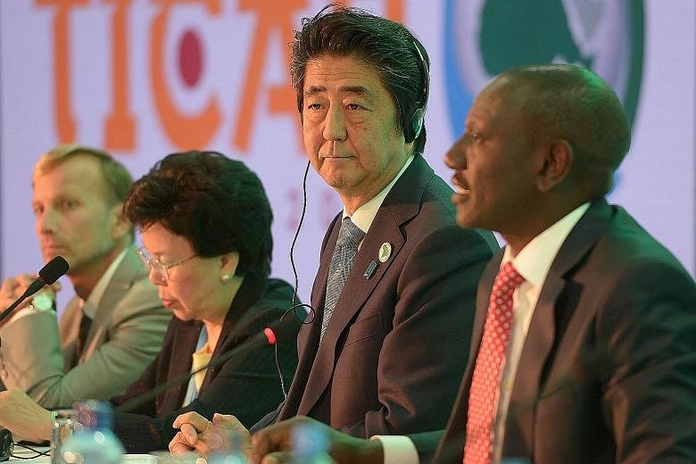 Mr Abe listens to Kenyan Deputy President William Ruto (right) during a session of the Tokyo International Conference on African Development, in Nairobi. While at the conference, being held in Africa for the first time, the Japanese Prime Minister pl