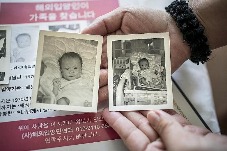 Ms Stapel showing baby photos of herself during a recent visit to Seoul, where she went to search for her birth parents. South Korea was once the world's leading exporter of babies, and every year, many return, looking for information about their pas