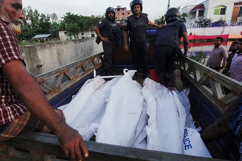 Bangladesh policemen escorting the bodies of suspected militants following an operation to storm a militant hideout in Narayanganj, some 25km south of Dhaka yesterday. Bangladeshi Prime Minister Sheikh Hasina said the successful raid will improve Ban
