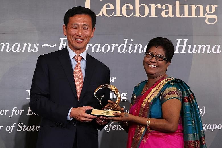 Mr Ong Ye Kung, Acting Minister for Education (Higher Education and Skills), presenting Madam Gurusamy Intrany with a Silent Heroes award last Saturday. Madam Intrany counsels couples on the verge of divorce, donates to old folks' homes and gives mon
