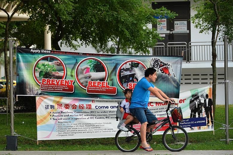 Above: Geylang Methodist School (Primary) pupils heading to school yesterday morning. The school, which is in the Aljunied area, had its compound fumigated last Saturday to prevent mosquito breeding. Below: A dengue-prevention banner in Aljunied Cres
