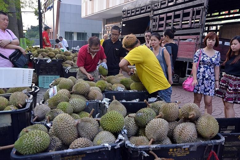 Fruit stall 717 Trading brings in about 50 baskets of durians a day, down from 200 during the peak of the harvest season.