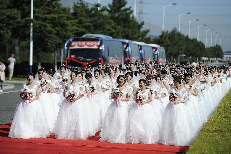 Anxious brides, all 162 of them, waiting for their wedding ceremony to begin at the manufacturing base of the CRRC Changchun Railway Vehicles Company in Changchun, capital of Jilin province, in north-east China. The railway carriage maker held a mass