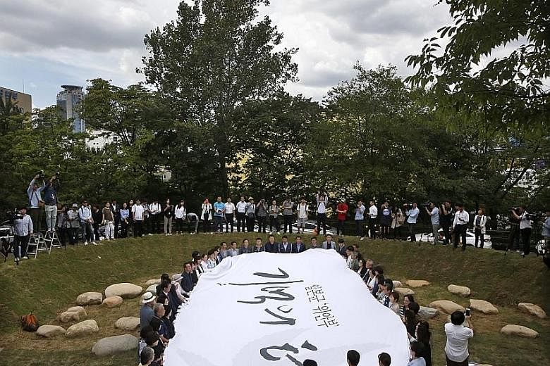 A ceremony to unveil the "Place for Memory of Comfort Women" being held at Mount Namsan in Seoul, South Korea, yesterday. The mayor of Seoul, politicians and former sex slaves were among those present. The structure, dubbed "The Navel of the World", 
