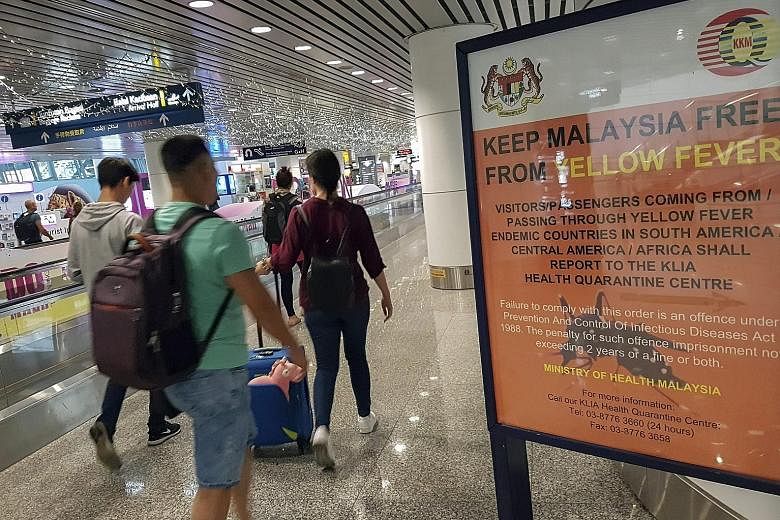 A travel advisory on yellow fever at Kuala Lumpur International Airport. Those returning to Malaysia from Zika-hit countries have been urged to go for testing.