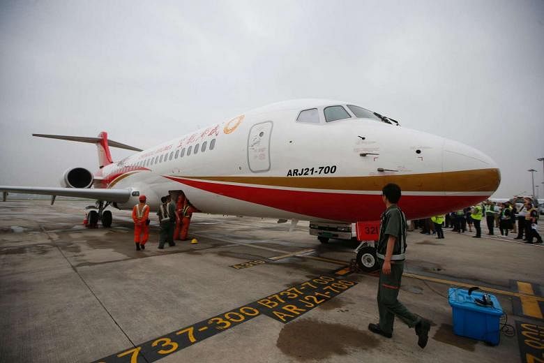 China's first domestically produced regional jet, the ARJ21, arriving at Shanghai Hongqiao Airport after making its first flight from Chengdu to Shanghai on June 28. It is made by the Commercial Aircraft Corporation of China, one of the investors in the n
