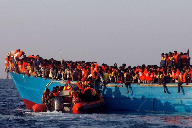 Migrants from Eritrea waiting as a rescue boat approached their overcrowded wooden vessel off the Libyan coast in the Mediterranean Sea on Monday. Forty rescue missions were carried out on Monday, making it one of the busiest days of life-saving in recent