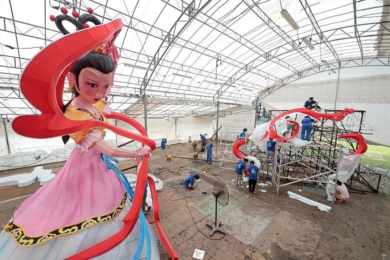 A 12m-tall lantern depicting Chang Er, the mythological moon goddess, is the centrepiece of this year's decorations. Steel worker Gan He Ping, 32, bending steel cables to form the skeleton of the jade rabbit. Nafa students designed the decorations be