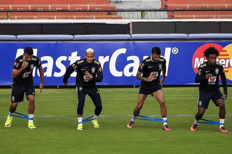 From left to right: Brazil footballers Neymar, Dani Alves and Willian training at Liga stadium in Quito, ahead of the Selecao's World Cup qualifier against Ecuador.