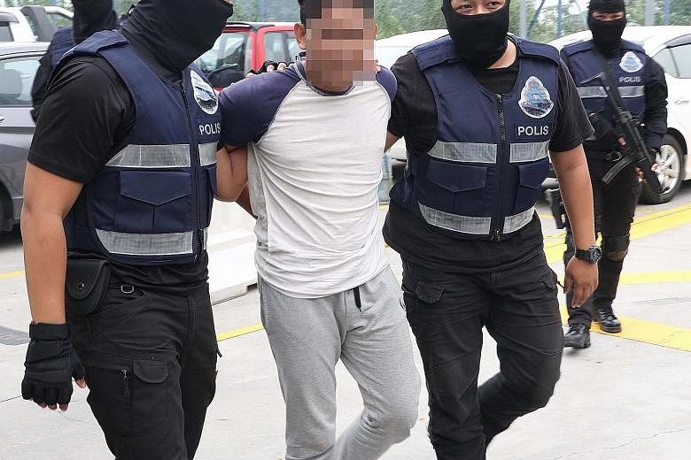 Above and left: The Bukit Aman Special Branch Counter- Terrorism Division picking up suspects in Kuala Lumpur, Selangor and Pahang over the weekend. The men were planning attacks on the eve of Malaysia's National Day.