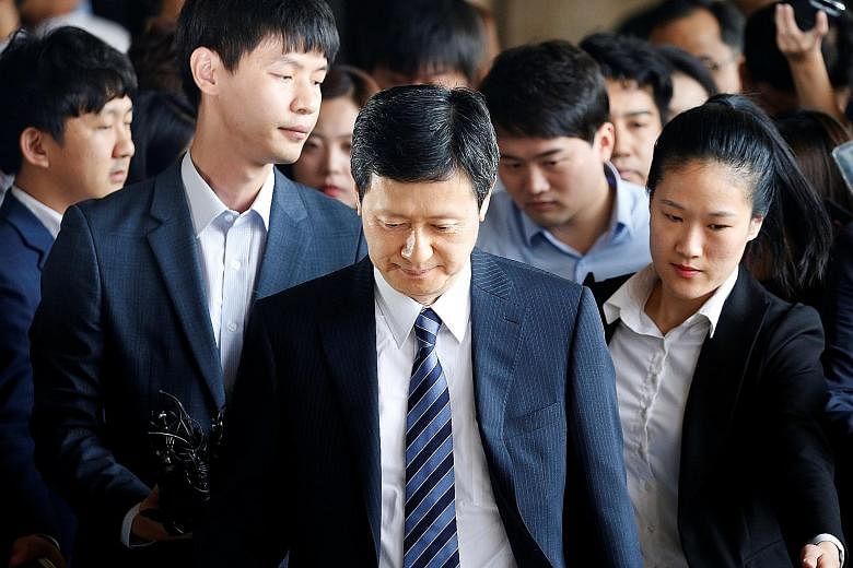 Lotte Group founder Shin Kyuk Ho's elder son Shin Dong Joo (centre) is in a bitter fight with his younger brother to wrest control of the family-run conglomerate, which spans 93 companies.