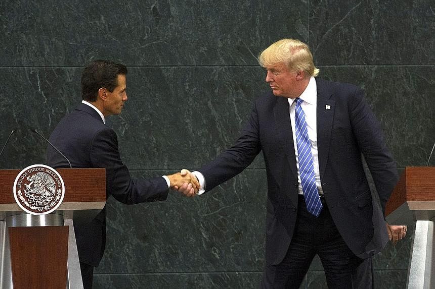 Fresh from a controversial visit to Mexico - where he met Mexican President Enrique Pena Nieto (far left) and where the wall was an especially contentious issue - Republican candidate Donald Trump pointedly made it the first issue in his 10-point pla