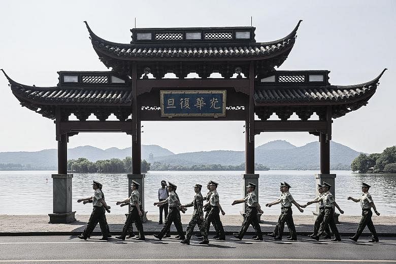 Paramilitary police officers marching by West Lake in Hangzhou on Monday. China's leading role at this weekend's summit will be a marked change from its outsider role at the first G-20 summit in 2008.