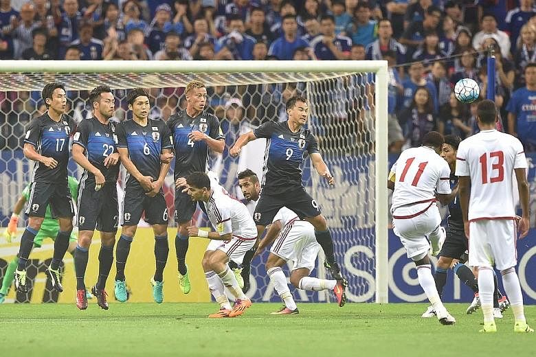 United Arab Emirates forward Ahmed Khalil (No. 11) equalises with a 20th-minute free kick. He went on to score the winner from the penalty spot, handing Japan a 2-1 loss in the World Cup qualifier.