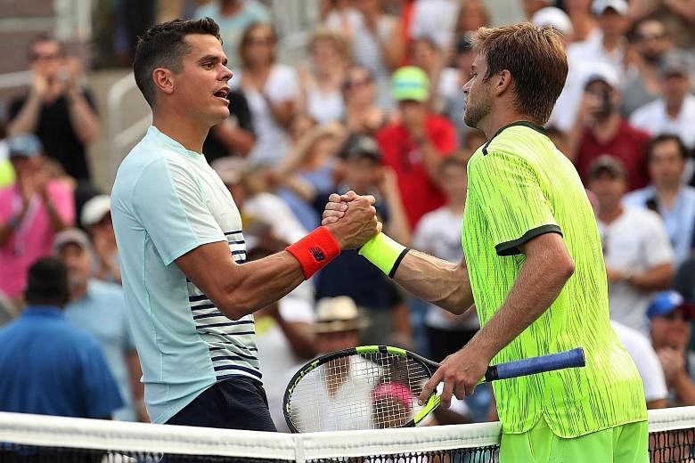 World No. 5 Milos Raonic (left) of Canada congratulates Ryan Harrison after their US Open second round match. The American qualifier has reached the third round of a Major for the first time in 20 appearances.