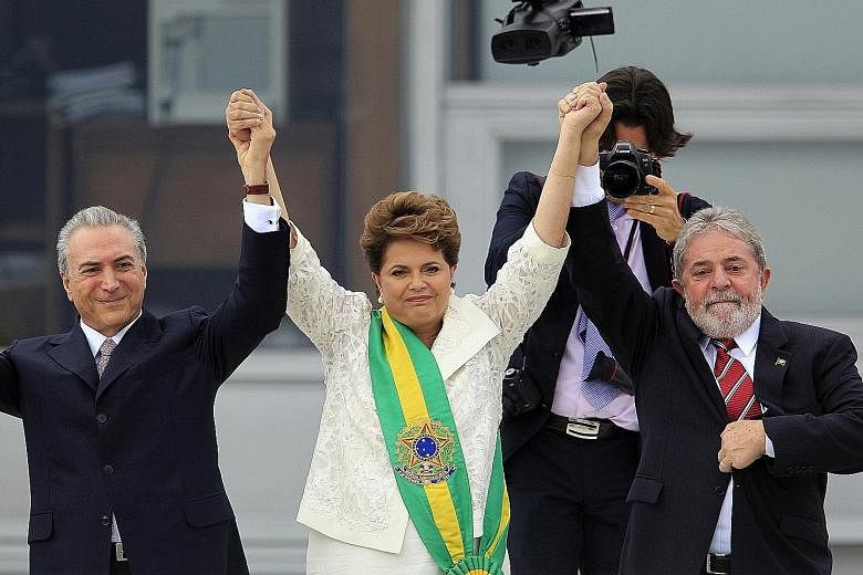 Ms Rousseff and Mr Temer (far left) with then outgoing President Luiz Inacio Lula da Silva outside Planalto Palace in Brasilia on Jan 1, 2011. Mr Temer, who has run Brazil since Ms Rousseff's suspension in May, inherits a bitterly divided nation.
