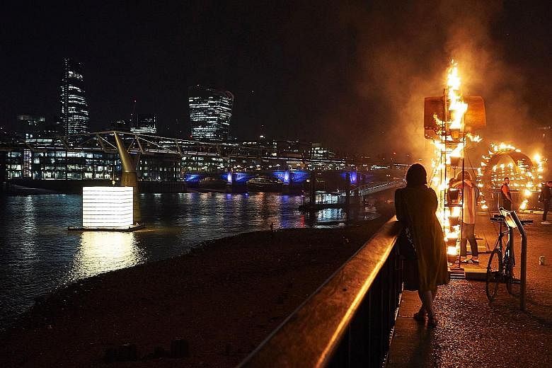 A "Fire Garden", designed by French fire masters Compagnie Carabosse, being performed outside the Tate Modern in central London on Thursday as part of the London's Burning festival of events commemorating the 350th anniversary of the Great Fire of Lo
