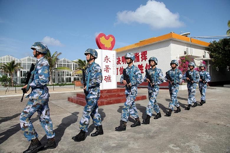 Chinese naval troops on patrol at Fiery Cross Reef in the Spratly Islands, also known as the Nansha Islands. China has sovereignty claims over the archipelago and controls several islands and reefs there.