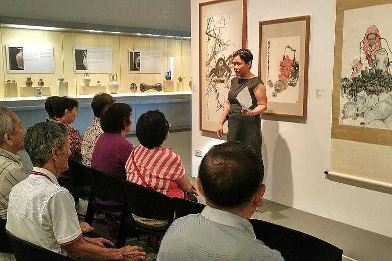 Seniors in an art reminiscence therapy session at NUS Museum. Six volunteer museum guides are trained to understand group dynamics, know how to elicit emotions and use paintings to relate to the seniors' memories and life experiences.