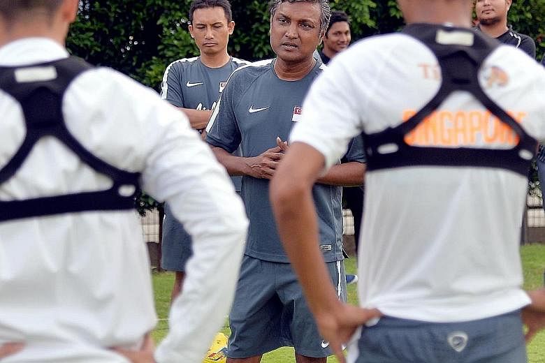 National caretaker football coach V. Sundramoorthy talking to his players during a training session. Singapore are drawn in Group A in the AFF Suzuki Cup in November with Thailand, the Philippines and Indonesia.