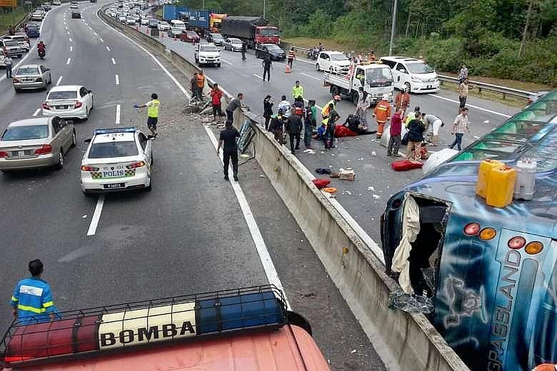 Above: The tour bus overturned on the Karak-KL highway while returning to Singapore from Genting Highlands on Wednesday. From left: Mr Navindran Manokaran, his mother, Madam Muniandy Barvathi, his father R. Manokaran and sister M. Priyatharsini.