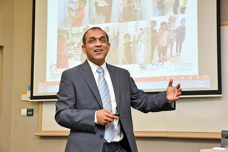 Prof Sumit (left) conducting a masterclass at NUS Business School last year, and with his younger sister and parents (right) in Uganda in 1992. The family moved to Africa when his father was working there as an economist with the World Bank.