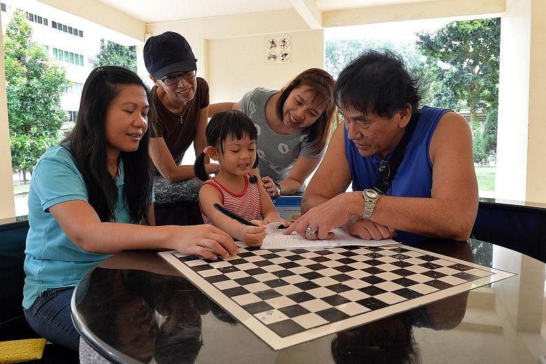 Neighbours have rallied round Mrs Foo (not in photo) since her husband's death in July. Some of the neighbours are seen here with Mrs Foo's elder daughter Gerardin. They are (from left) Ms Castillo, Mrs Cheong, Madam Yeo and Mr Choo.