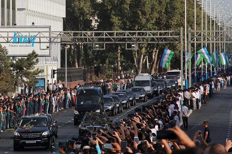 Uzbek President Islam Karimov (above) was pronounced dead late on Friday. Yesterday, crowds lined the roads as the cortege drove through Tashkent (right). He was buried in a cemetery in Samarkand.
