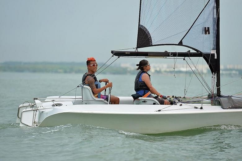 Jovin Tan (far left) with his sailing partner Yap Qian Yin training for the Paralympics. Tan hopes that he can eventually become a sailing coach for both para- and able-bodied sailors.