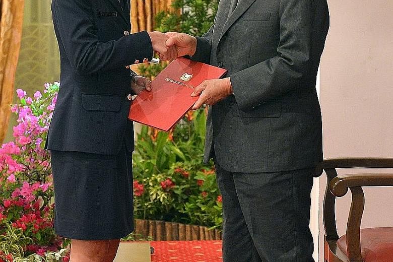 President's Scholar Natasha Ann Lum receiving her award from President Tony Tan Keng Yam at the Istana on Aug 23. As may be seen in Miss Lum's case, students may still achieve outstanding results even if they do not enter top schools.