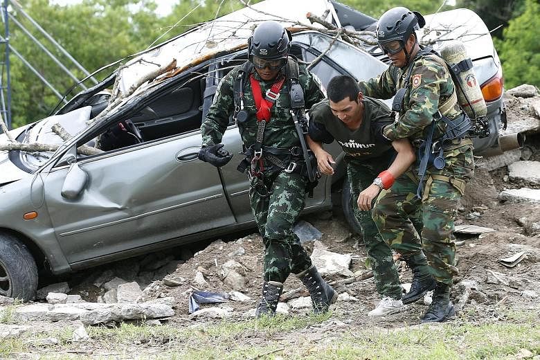 Military personnel from Laos and Thailand taking part in a humanitarian aid and disaster relief exercise yesterday at a military base in Chonburi province, Thailand. Hosted by Thailand, Laos, Russia and Japan, the Military Medicine - Humanitarian Ass