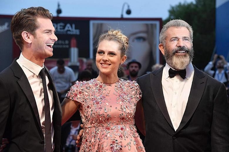 Director Mel Gibson (above right) with Hacksaw Ridge's cast members - actor Andrew Garfield and actress Teresa Palmer - at the film's premiere in Venice on Sunday. Celebrities on the red carpet included Sistine Stallone, daughter of actor Sylvester Stallo