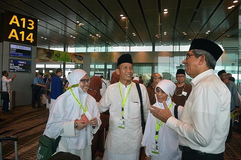 Dr Yaacob Ibrahim with Miss Nur Asyura Suratman (far left), 21, a software engineering technician; her father Suratman Haji Hussein, 60, an oil refinery plant operations supervisor; and mother Hamidah Samsuri, 58, a housewife, before they left on the