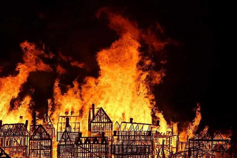 A 120m-long model of the 17th-century London skyline being set alight on the River Thames on Sunday to mark the 1666 Great Fire of London. The blaze paved the way for the building of today's modern metropolis.