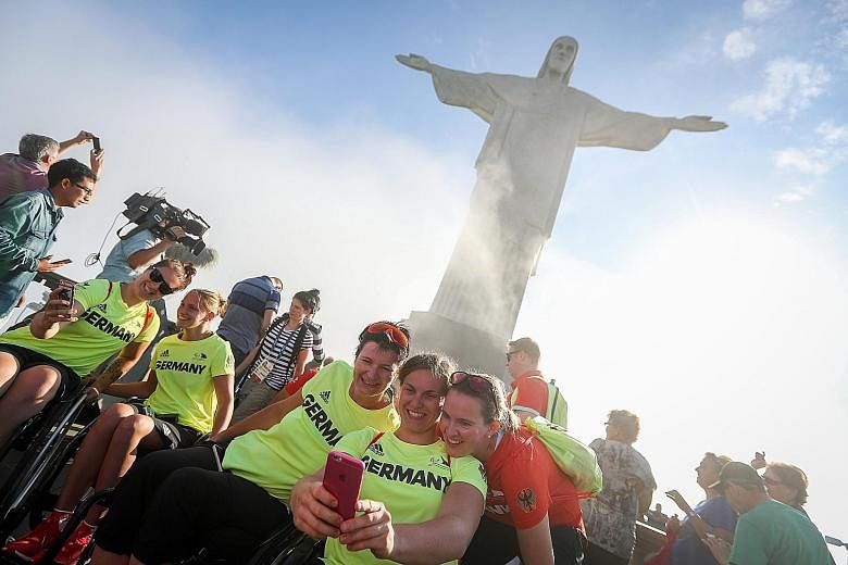 Members of the German women's national wheelchair basketball team take wefies in front of the statue of Christ the Redeemer, a leading Rio landmark.
